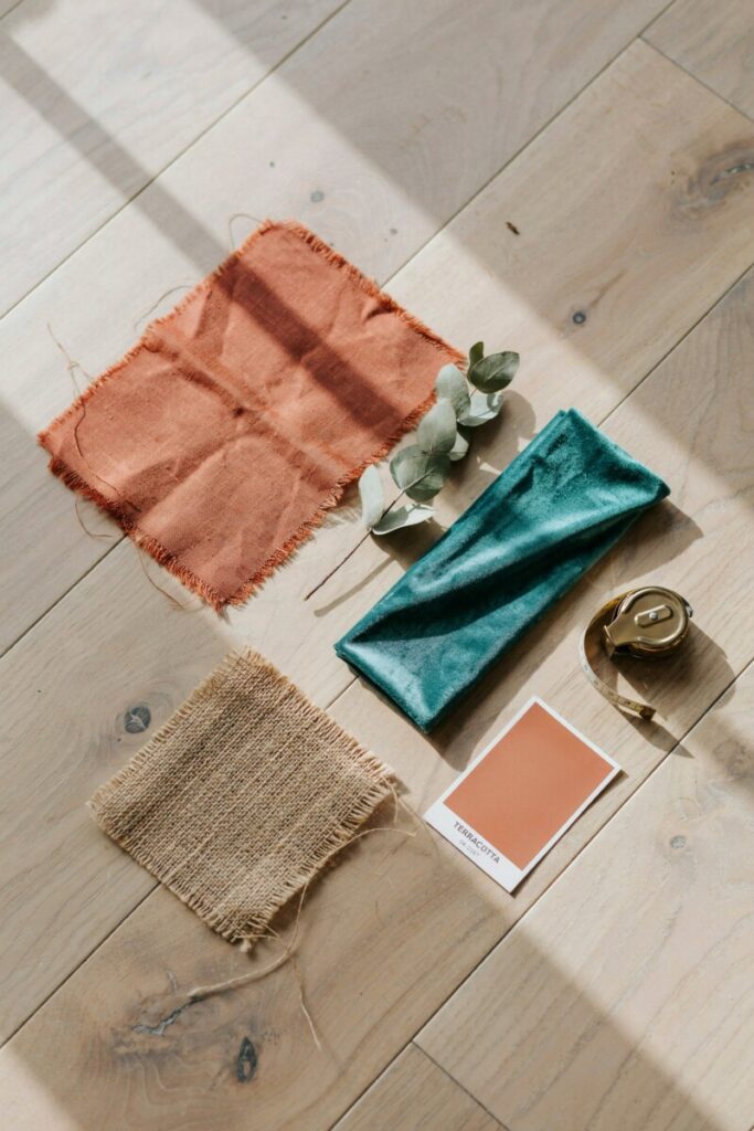 Bohemian color palette flatlay featuring terracotta, teal, and warm neutral fabric swatches.